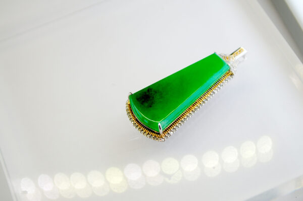 A stunning natural ice-green jade pendant elegantly set in 18K gold (white/yellow) with sparkling yellow and white diamonds, showcasing timeless beauty and craftsmanship.