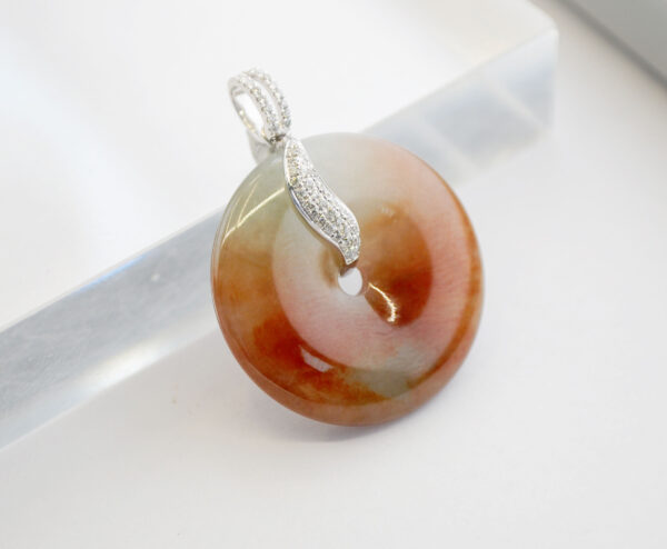 A stunning close-up of the Natural Ice-type Red Jadeite Retro Pendant, showcasing its rich red hue transitioning to a clear base, set in elegant 18K white gold with sparkling diamonds.