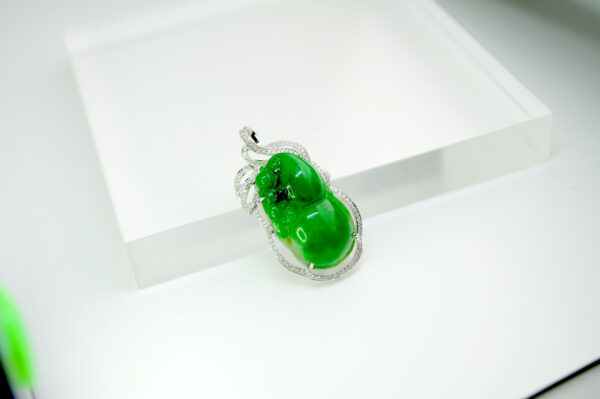 A stunning full-green jadeite gourd pendant intricately carved and set with sparkling 18K white gold and diamonds, showcasing traditional Eastern charm and contemporary craftsmanship.