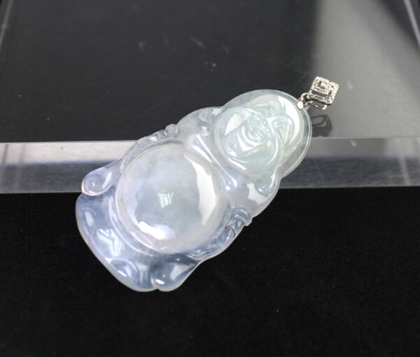 A stunning Natural Ice-type Jadeite Standing Buddha Pendant featuring translucent jadeite with a delicate glow, set in elegant 18K white gold and adorned with sparkling diamonds. The intricate carving showcases a serene Buddha with smooth, flowing details.