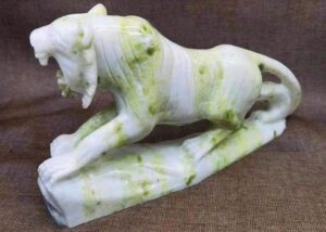 Polished Lantian Jade fragment showing celadon-green and white banding.
