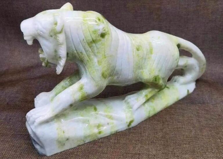 Polished Lantian Jade fragment showing celadon-green and white banding.