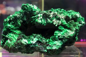 Polished malachite slab showing concentric green bands and silky luster.