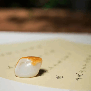 Artisan carving Hetian jade: “Craftsman hand-carving moderate motifs on Hetian jade, demonstrating balanced refinement.”