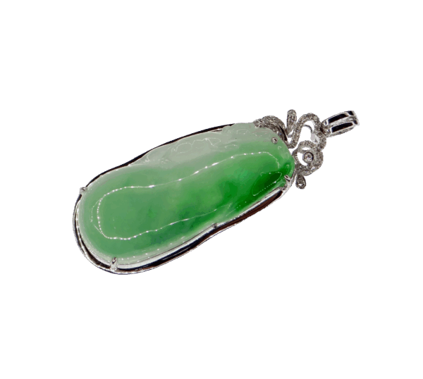 A stunning ice-green natural emerald pendant carved into a melon shape, symbolizing good fortune. The 18K gold clasp is delicately inlaid with diamonds, enhancing its luxurious appeal.