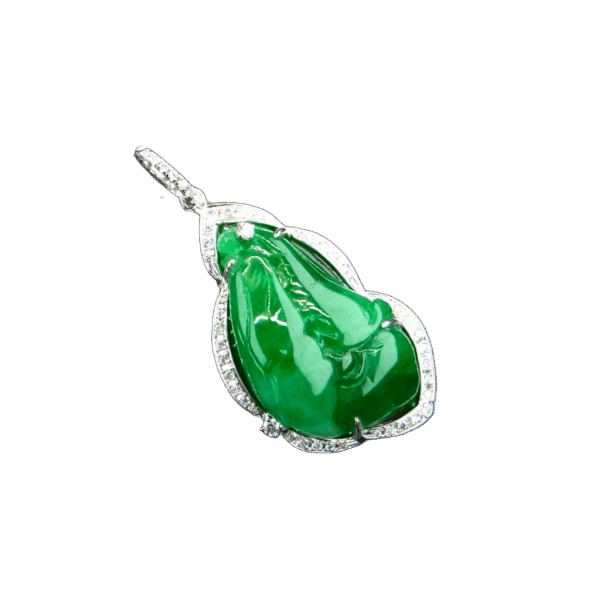 A stunning close-up of the Natural Emerald Orchid Pendant, showcasing its vivid green emerald carved into an orchid, surrounded by sparkling diamonds set in 18K white gold.