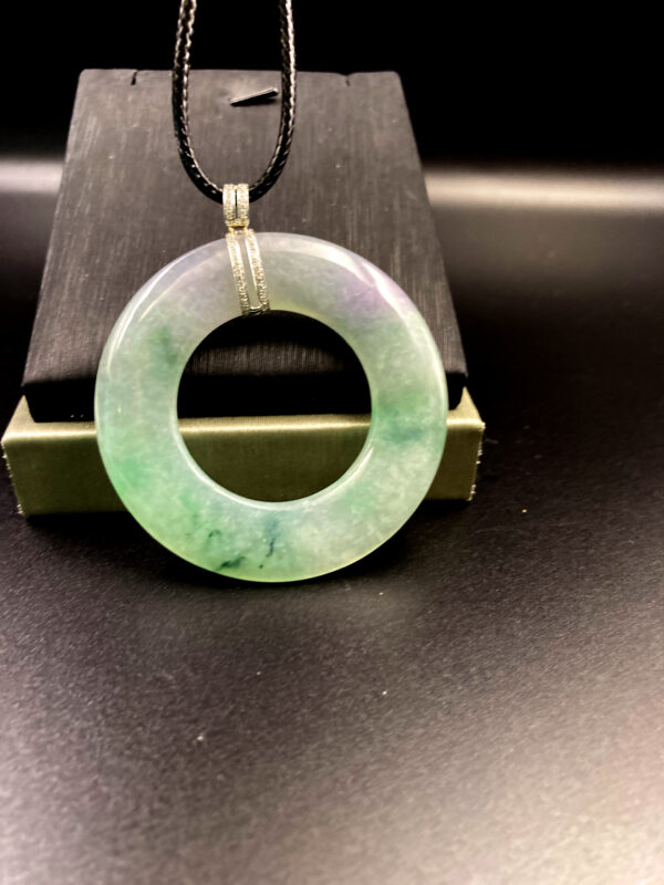 A stunning round "Spring with Color" jadeite pendant (53x5 mm) showcasing a harmonious blend of light purple and green hues, set in 18K white gold with a sparkling diamond clasp. The fine, translucent texture and smooth polish highlight its natural beauty.