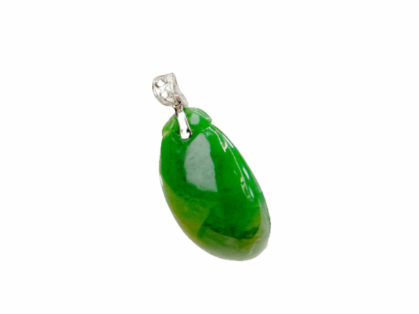 A stunning close-up of a full-green jadeite melon-shaped pendant with intricate carving, paired with a polished 18K white gold clasp, resting on a velvet background.