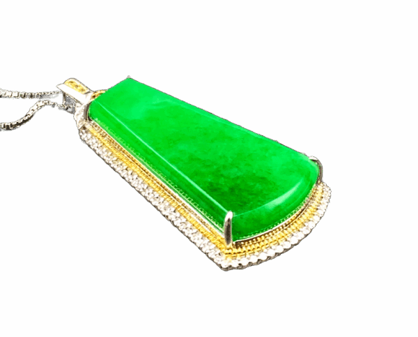 A stunning natural ice-type jadeite pendant with vibrant green color, finely polished and set in luxurious 18K gold (white/yellow) with diamond embellishments, showcasing elegance and sophistication.