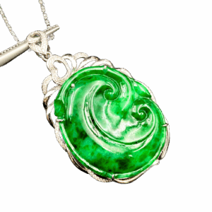 A stunning Flower Green Jadeite Pendant featuring swirling natural patterns, set in 18K white gold with sparkling diamond accents. The heart-shaped clasp adds a delicate touch, making it a versatile accessory for any outfit.
