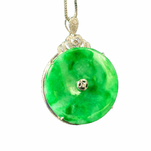 A stunning Natural Icy Flower Green Jadeite Pendant set in 18K white gold with sparkling diamonds. The jadeite displays a delicate mix of vibrant green and subtle cyan hues, polished to a smooth, round-edged antique-inspired design for timeless elegance.