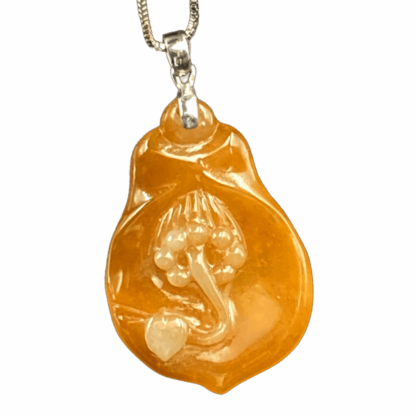 A stunning close-up of the Natural Ice Yellow Jadeite Magnolia Pendant, showcasing its warm golden hue, delicate floral carving, and sleek 18K white gold clasp on a neutral background.