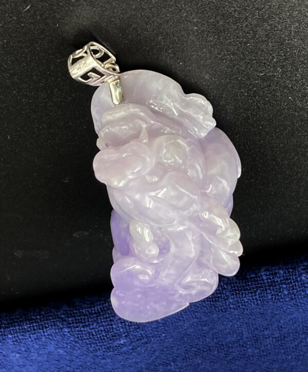 A stunning close-up of the Natural Ice Yellow Jadeite Magnolia Pendant, showcasing its warm golden hue, delicate floral carving, and sleek 18K white gold clasp on a neutral background.