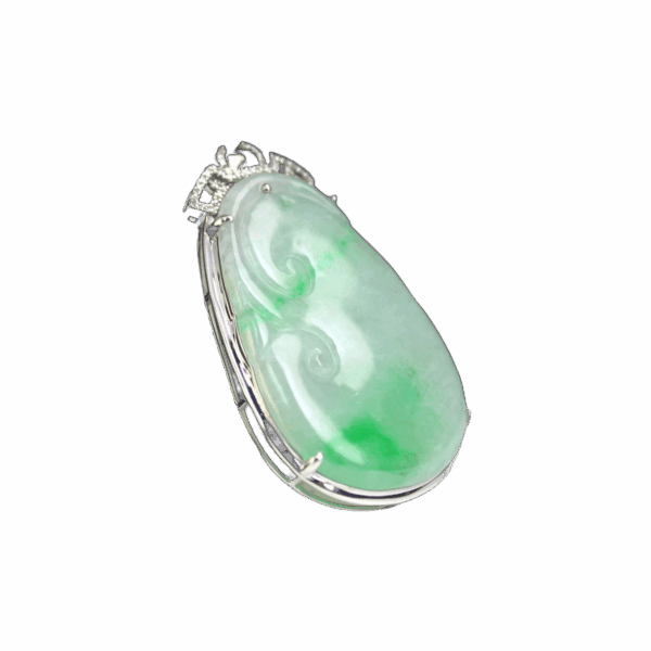 A stunning Natural Emerald Ruyi Pendant featuring ice-type floating green emerald, elegantly inlaid with 18K white gold and sparkling diamonds, showcasing traditional oriental design with modern craftsmanship.