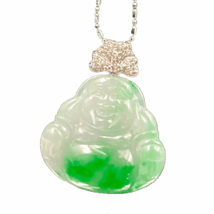 A stunning close-up of the Natural Jadeite Ice-white Buddha Pendant, showcasing its delicate floating green patterns on a translucent base. The 18K white gold diamond clasp sparkles elegantly, highlighting the intricate craftsmanship.