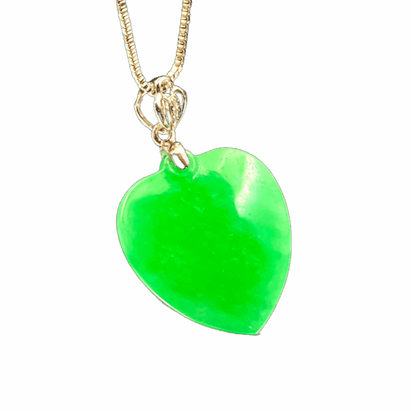 A stunning Natural Emerald Heart Pendant featuring a full-green, ice-type emerald carved into a smooth apricot heart shape, set in luxurious 18K white gold with delicate diamond accents. The pendant glistens under light, showcasing its rich color and exquisite craftsmanship.