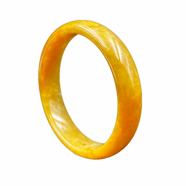 A lustrous honey-yellow jadeite bangle with a flawless, glossy surface, showcasing its natural color gradient and delicate internal structure. The round design fits elegantly on the wrist, reflecting refined craftsmanship.