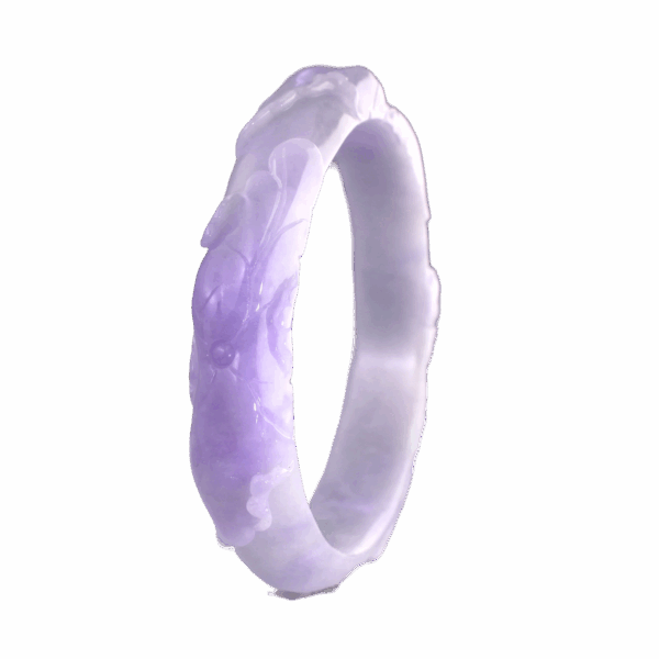 A stunning close-up of the Natural Violet Jadeite Relief Bracelet, showcasing its intricate floral relief carvings and rich violet hue against a soft background. The polished jadeite surface reflects light beautifully, highlighting its fine texture and craftsmanship.