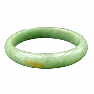 A stunning Natural Dou Green Feicui Concubine Bracelet, showcasing a smooth oval design with a warm dou-green hue and subtle yellow accents, resting elegantly on a velvet display.