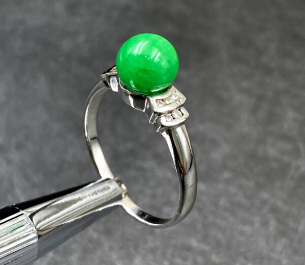 A stunning Natural Douqing Jade Ring featuring a rich green jade centerpiece, elegantly set in polished 18K white gold and adorned with sparkling micro-set diamonds.