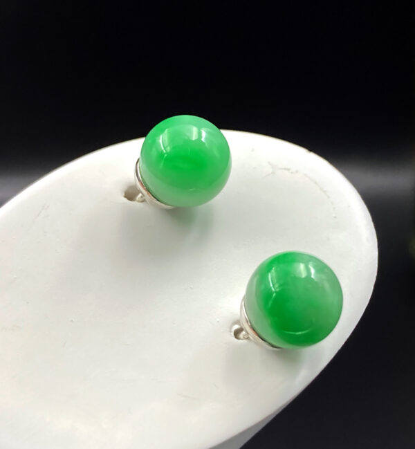 Elegant Bai Di Qing jadeite earrings featuring smooth, round 7.9mm beads with striking green and white contrast, set in minimalist 18K white gold for a modern yet classic look.