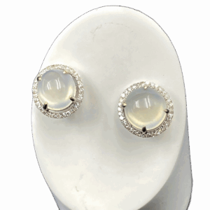 A stunning pair of high-ice jadeite earrings featuring a translucent 9.5x9.5x7 mm jadeite egg face, meticulously set in 18K white gold and encircled by brilliant diamonds. The jadeite’s smooth polish and natural glow are enhanced by the diamond halo, creating a luxurious and refined aesthetic.