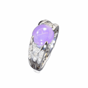 A stunning close-up of the Natural Ice-type Violet Jade Cabochon Ring, showcasing its translucent violet hue, 22K white gold band, and sparkling diamond accents on a velvet background.