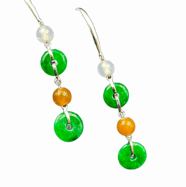 A pair of exquisite icy jadeite safety buckle earrings with natural green hues, delicately suspended from metal hooks and chains. The polished jadeite showcases a cool, translucent glow, complemented by subtle bead accents for a sophisticated layered look.