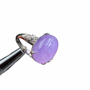 A stunning oval cabochon violet jadeite ring, showcasing vivid color and excellent transparency, set in 18K white gold with sparkling sapphires and diamonds.