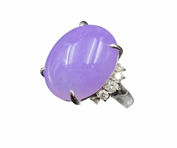 A stunning close-up of the Natural Ice-type Violet Jadeite Cabochon Ring, featuring a lustrous violet jadeite centerpiece set in gleaming platinum with delicate diamond accents. The cabochon cut highlights the jade's translucent glow, while the platinum band adds a touch of modern sophistication.