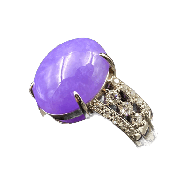 A stunning natural ice-type violet jadeite cabochon ring with a delicate pale purple hue, set in platinum and accented with sparkling diamonds on both sides of the band.