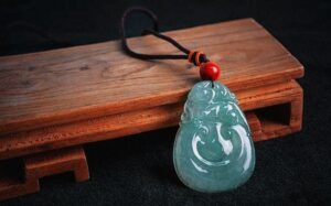 Comparison of Hetian mutton fat jade versus Canadian green jade pendants