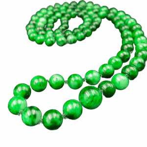 A stunning close-up of Natural Flower-veined Jade Pagoda Beads, highlighting the intricate color veins and smooth polish of each round bead, elegantly draped or layered for versatile wear.