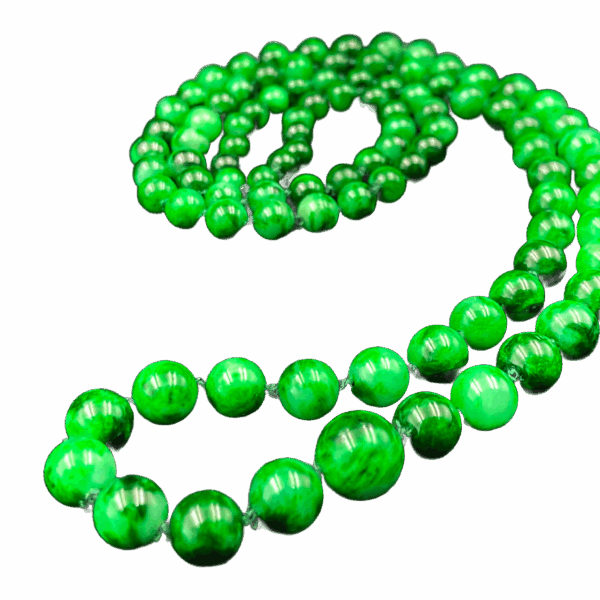 A stunning close-up of the Natural Jadeite Flower-Green Pagoda Beads Necklace, highlighting the rich emerald-green hues and intricate natural patterns of each jadeite bead. The necklace is elegantly draped, showcasing its smooth polish and lustrous glass-like finish.