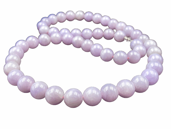 A stunning close-up of natural violet jadeite beads with a smooth, polished surface, showcasing their soft purple-to-pink gradient. The 18K white gold clasp adds a refined touch, complementing the beads' elegance.