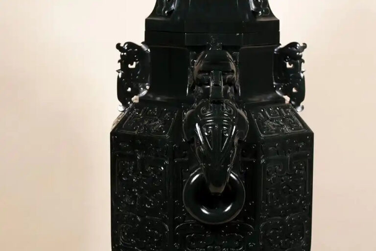 Close-up of taotie motif on jade surface demonstrating deep relief carving technique