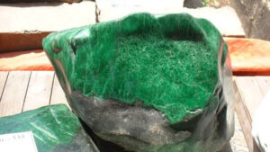 Polishing powder residue on damp cloth after wiping treated jadeite surface