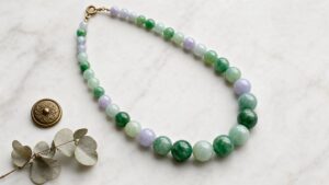Lustrous jadeite bead necklace displayed on silk, evoking serene elegance